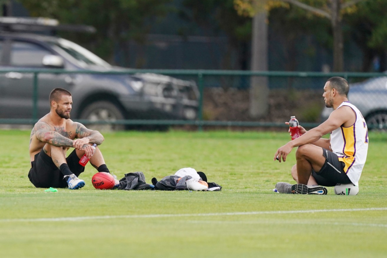 At a distance: Melbourne Storm player Sandor Earl and former teammate Will Chambers training in Melbourne. 