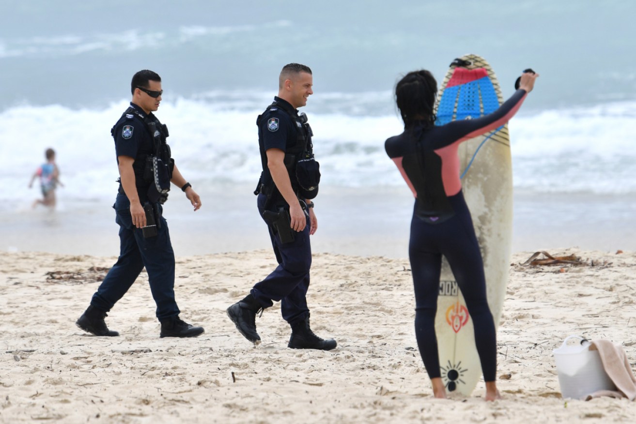 Police patrol the beach at Burleigh Heads, on Queensland's Gold Coast. 