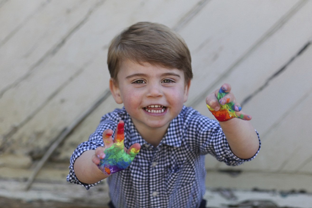 Young Prince Louis proudly shows off his paint-stained hands in one of his birthday photos.