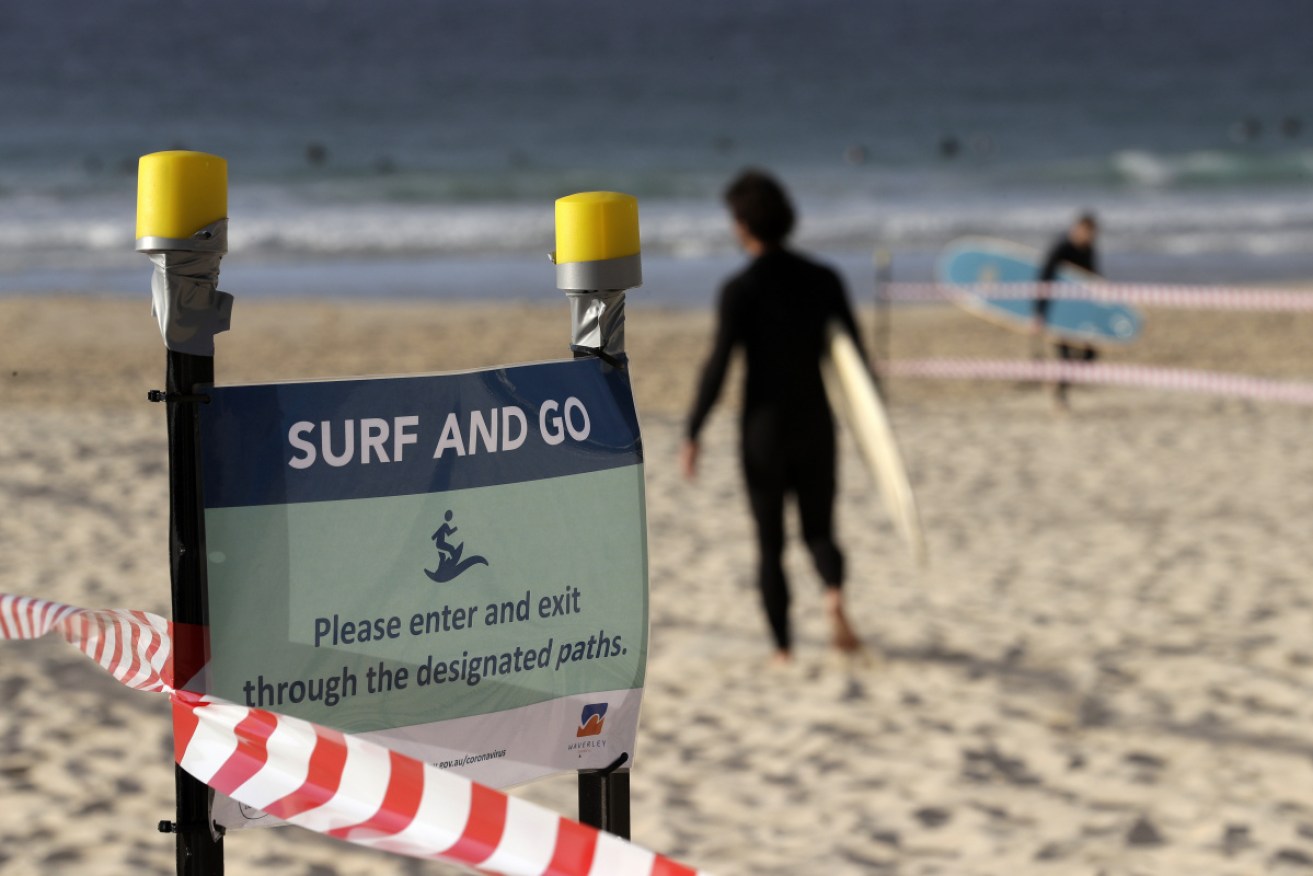 A sign at Bondi on Tuesday, urging beach users to ‘surf and go’.