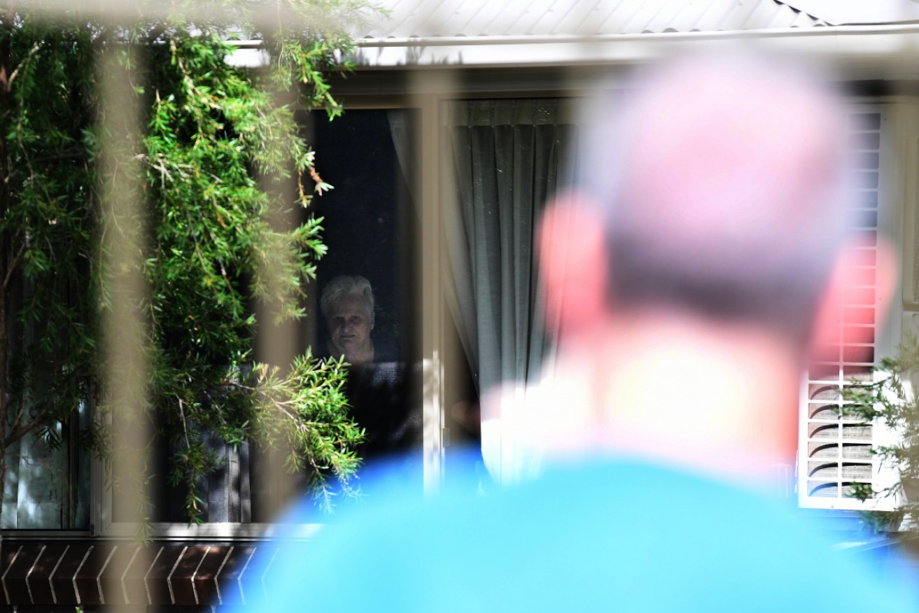 Newmarch House resident Patricia Shea looks out at her son, Anthony Bowe (foreground).