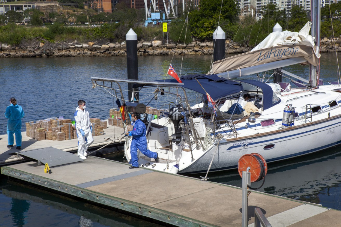 Specialist forensics officers unload a suspected methylamphetamine haul from the yacht at Balmain on Saturday. 