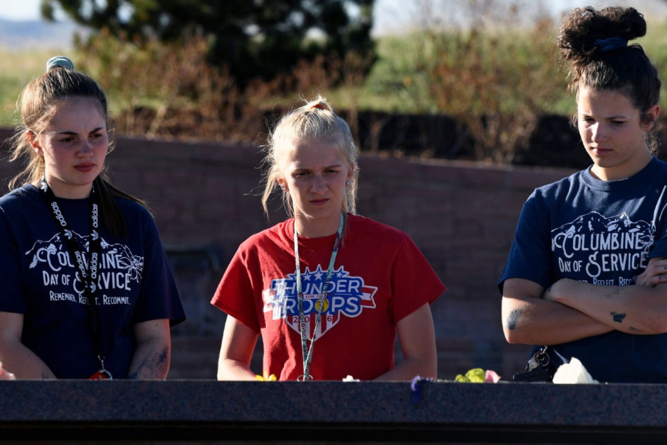 Students from Columbine High School pay their respects to victims at the 20th anniversary of the horrific school shooting..