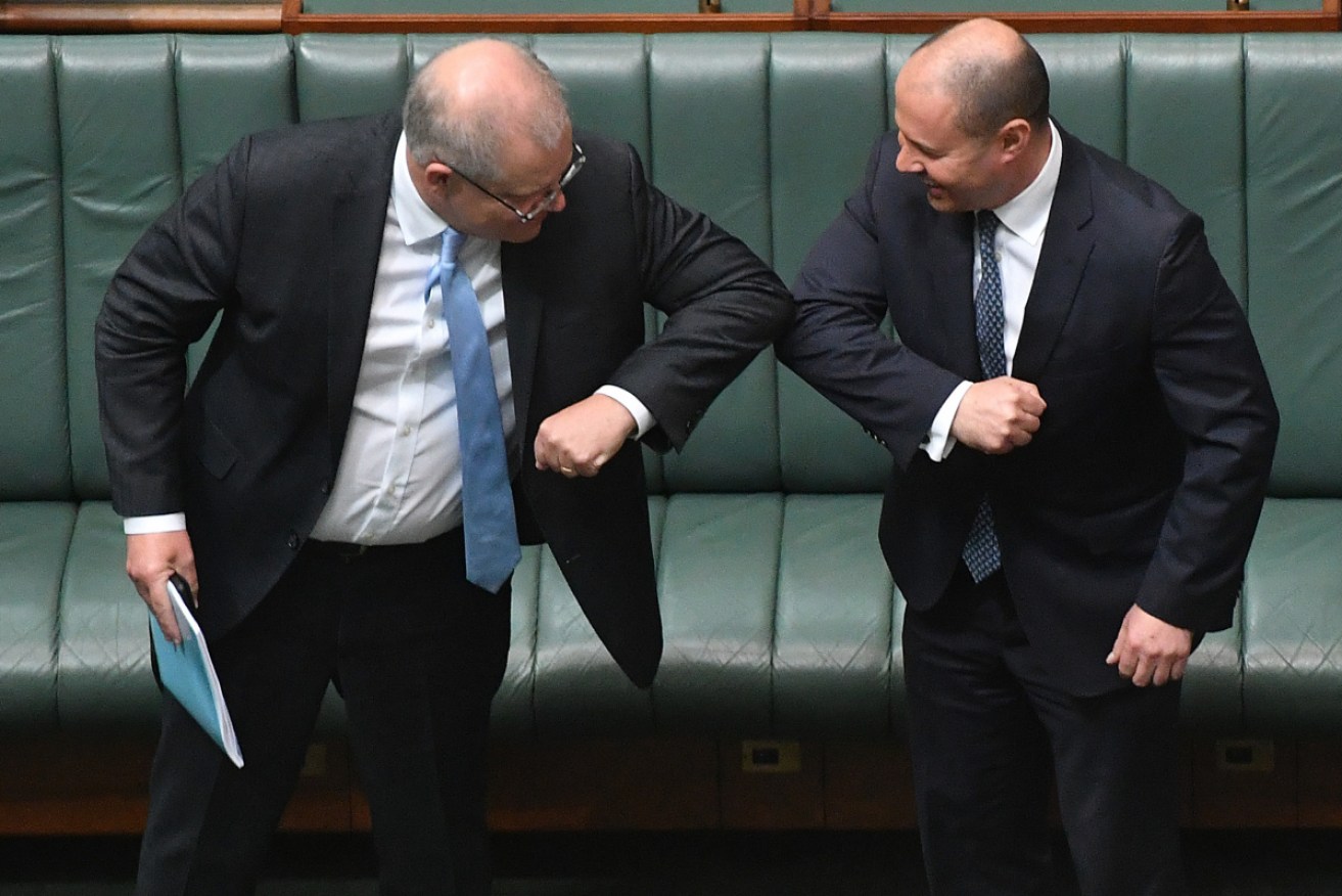 Scott Morrison and Treasurer Josh Frydenberg bump elbows after the PM's speech.
