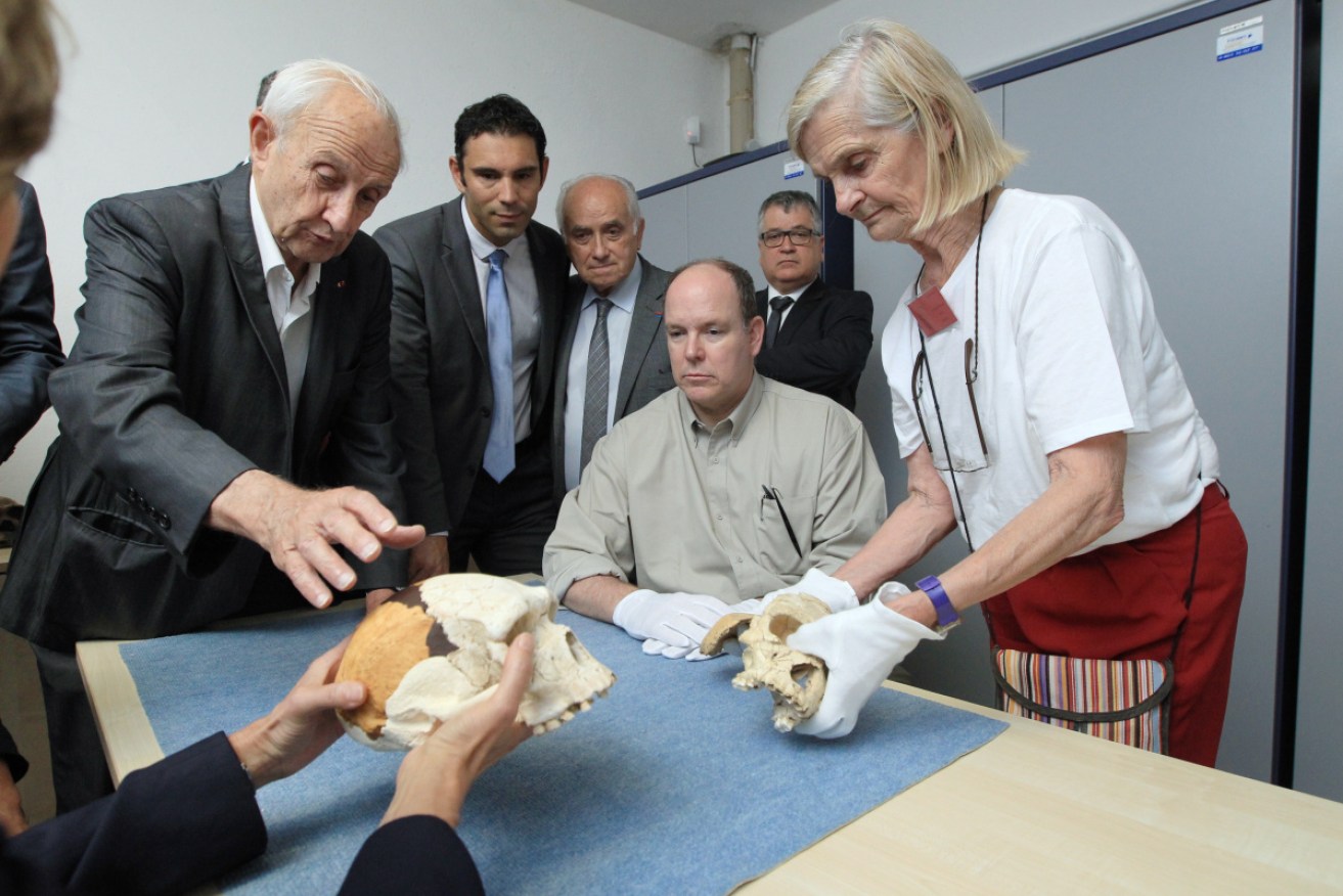 Prince Albert of Monaco (c) with French archeologist, geologist and prehistorian Henri Delumley (l) is shown the skull of a Tautavel man.