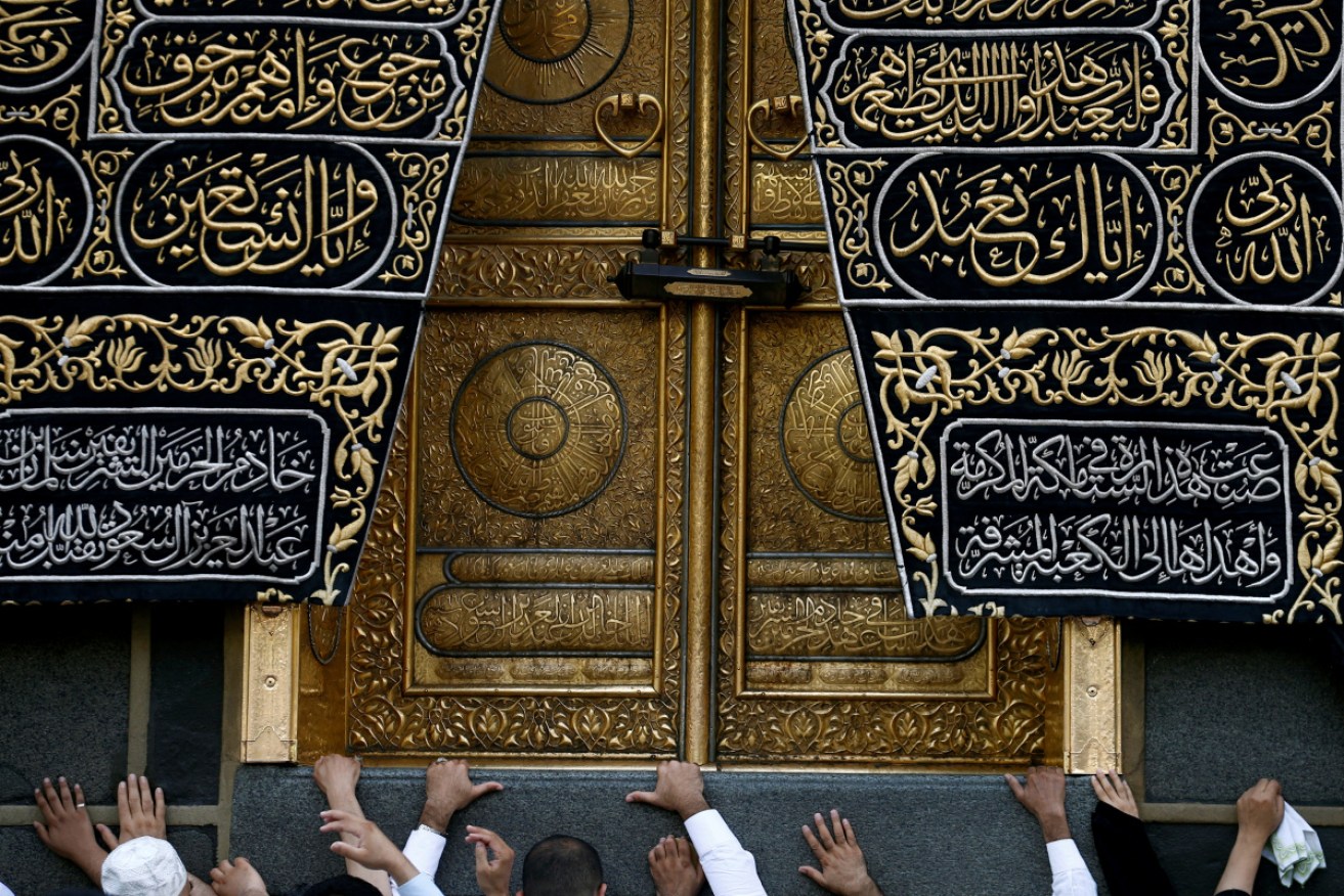 Muslims in May 2018 touch the Kaaba at the Grand Mosque during the holy fasting month of Ramadan at Mecca, Saudi Arabia.