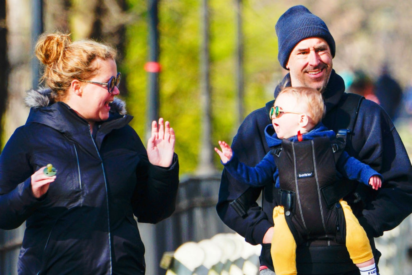 Amy Schumer, husband Chris Fischer and the recently renamed baby Gene.