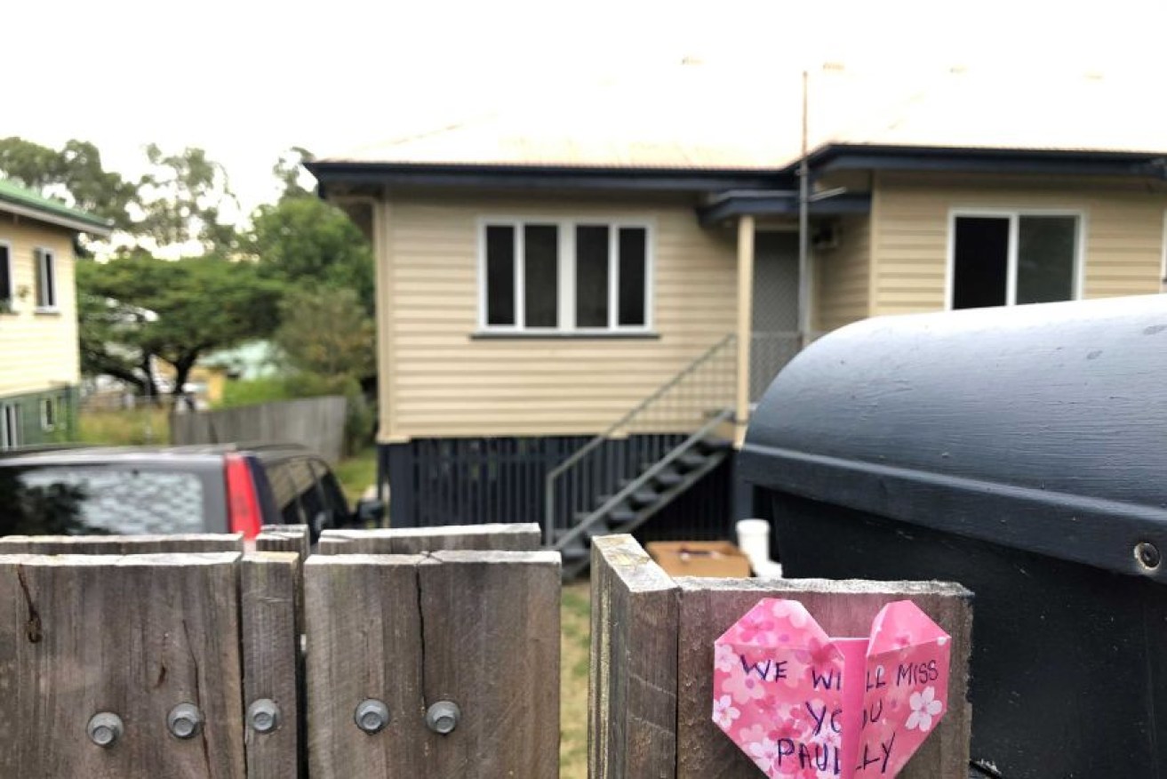 The home where two teenage boys were found locked inside a room after police found a man dead in the front yard.