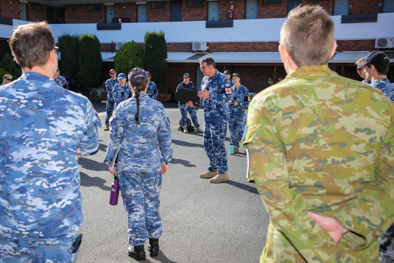 RAAF Squadron Leader Cameron Brockel leads a daily briefing at a Burnie hospital during the strict lockdown.