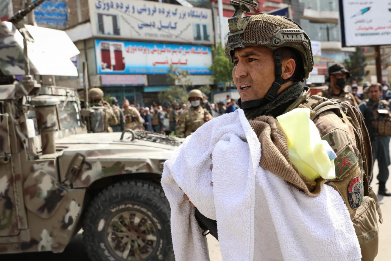 An Afghan soldier with a baby at the scene of the deadly attack on the Doctors without Borders hospital in Kabul.