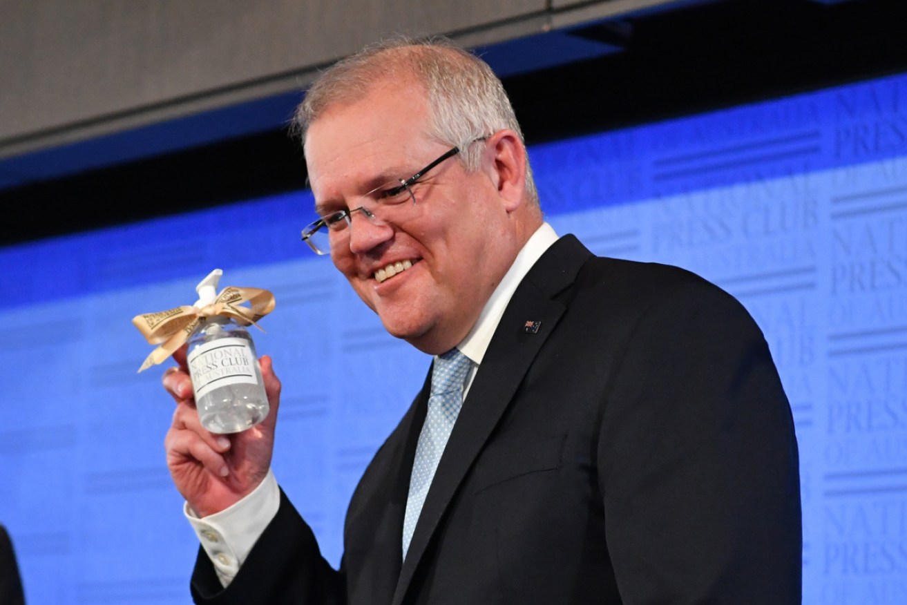 Mr Morrison with a gift of hand sanitiser after Tuesday's Press Club speech.