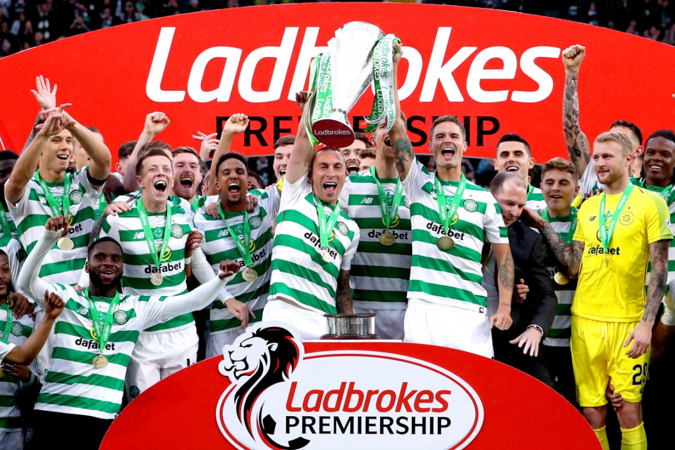 Celtic's Scott Brown and Mikael Lustig celebrate with the 2018-19 trophy after winning the Scottish Premiership.