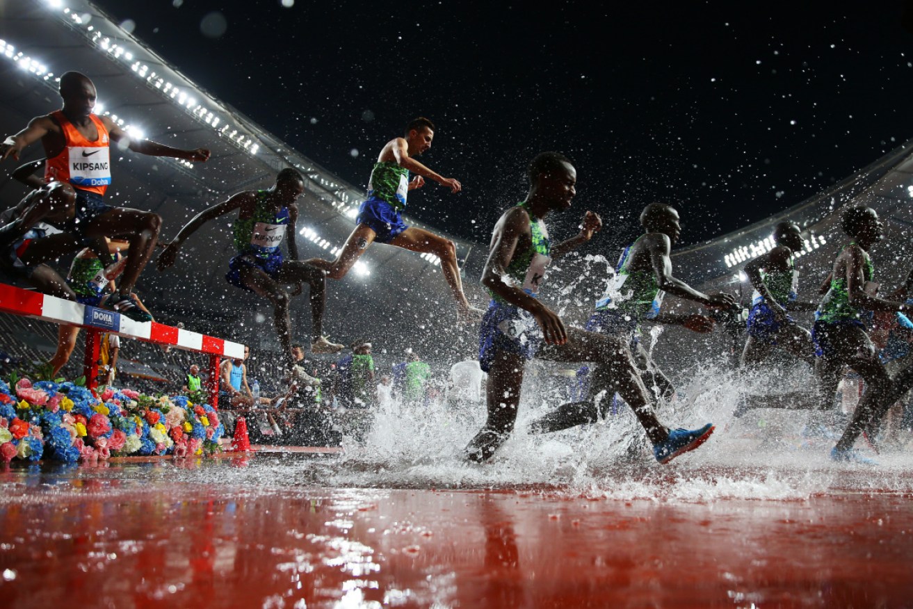 Athletes clear the water jump in the men's 3000 metres Steeplechase at the Diamond League event in May 2019 in Doha, Qatar. 