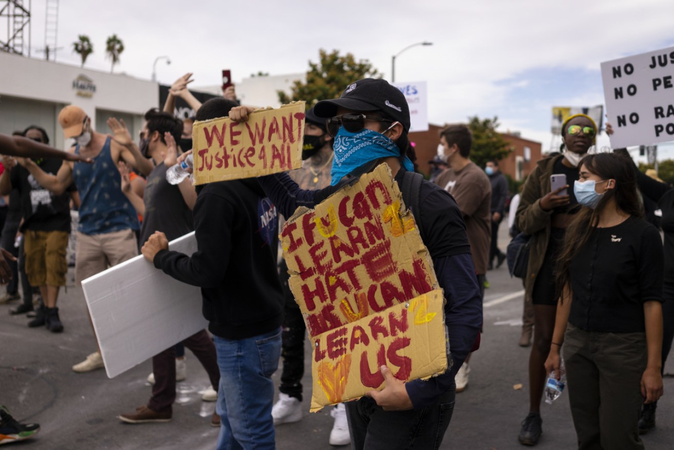 Protesters face down riot police in Fairfax, Los Angeles on Sunday after George Floyd's murder by Minneapolis police.