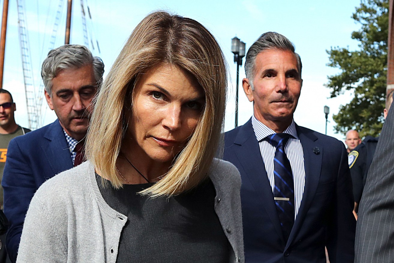 Lori Loughlin and her husband Mossimo Giannulli leave a Boston court in August 2019.