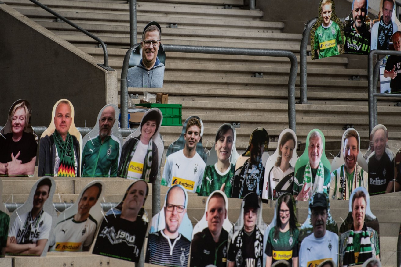 Cardboard cutouts in the stands await returning Bundesliga players.
