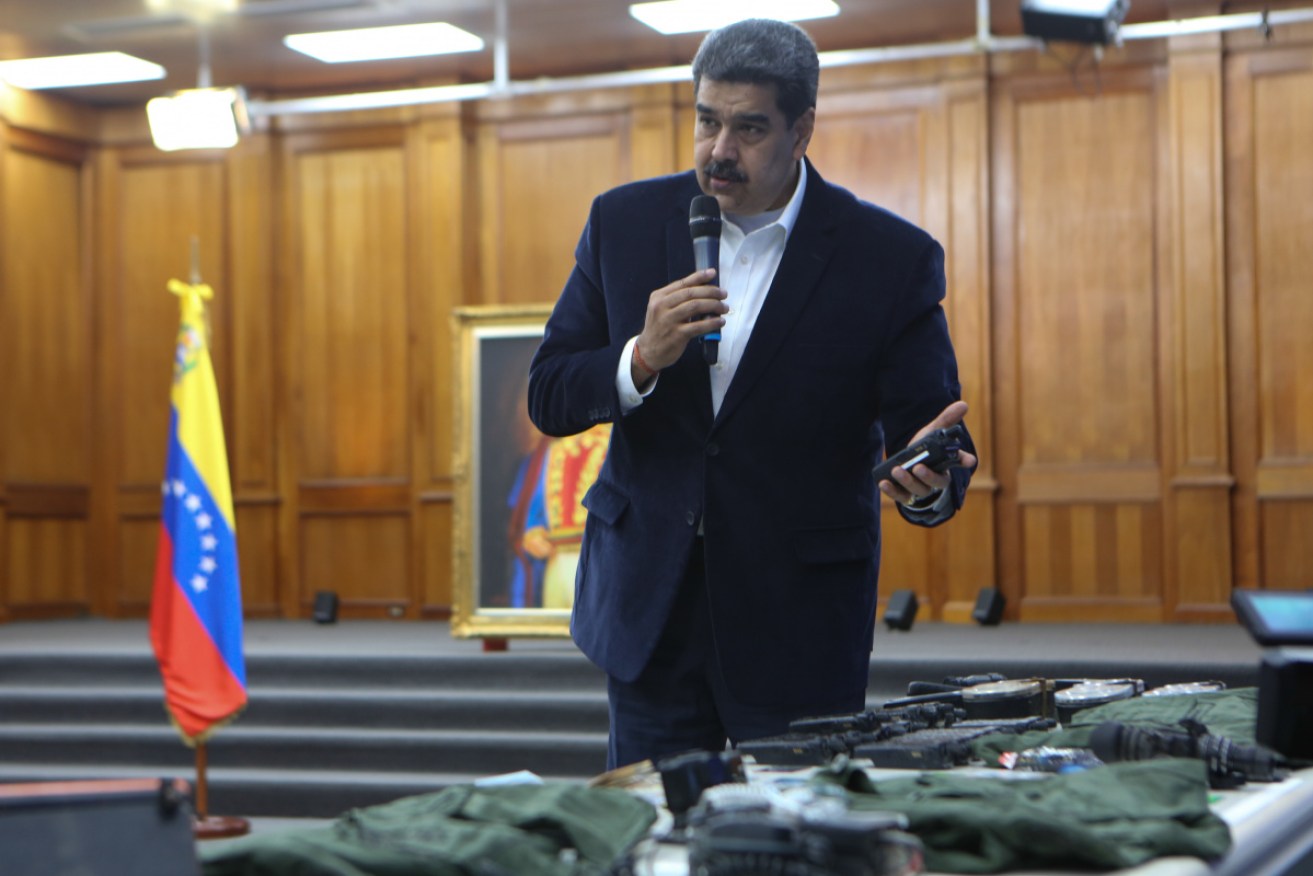 Venezuelan President, Nicolas Maduro displays seized armament and passports.