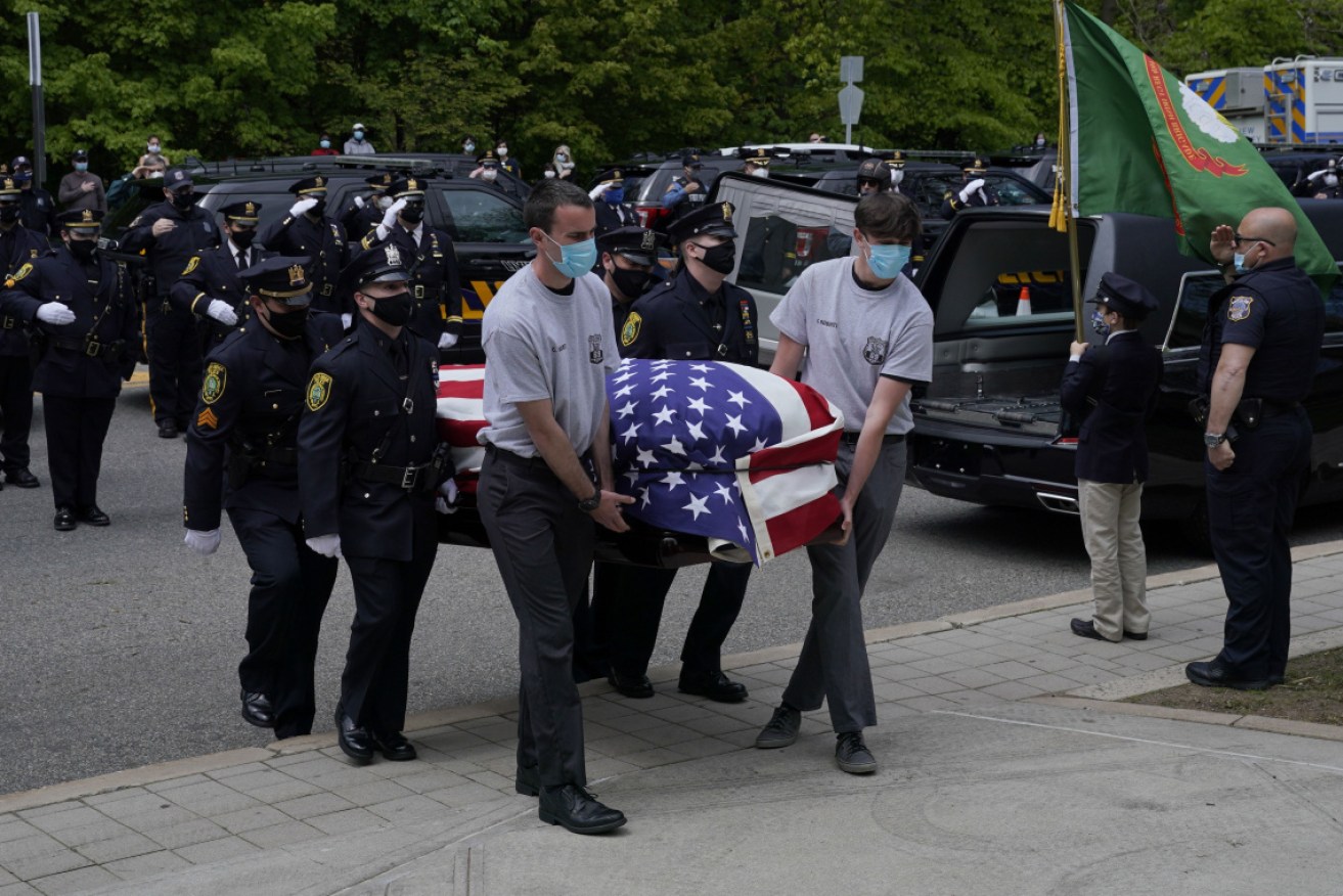 Pallbearers carry the casket of another coronavirus victim in New Jersey.