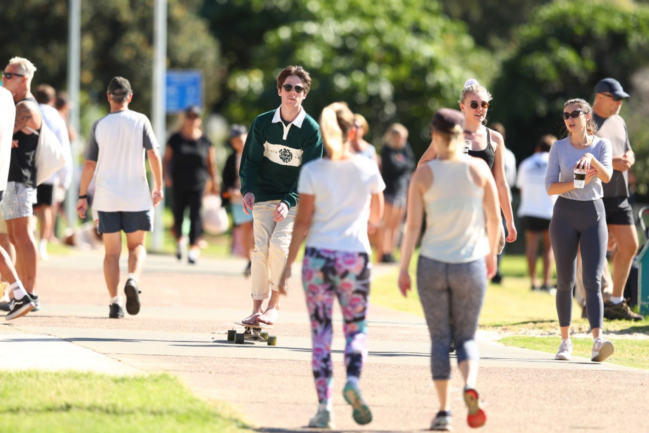 People walk along Burleigh Heads foreshore on the Gold Coast on Saturday.