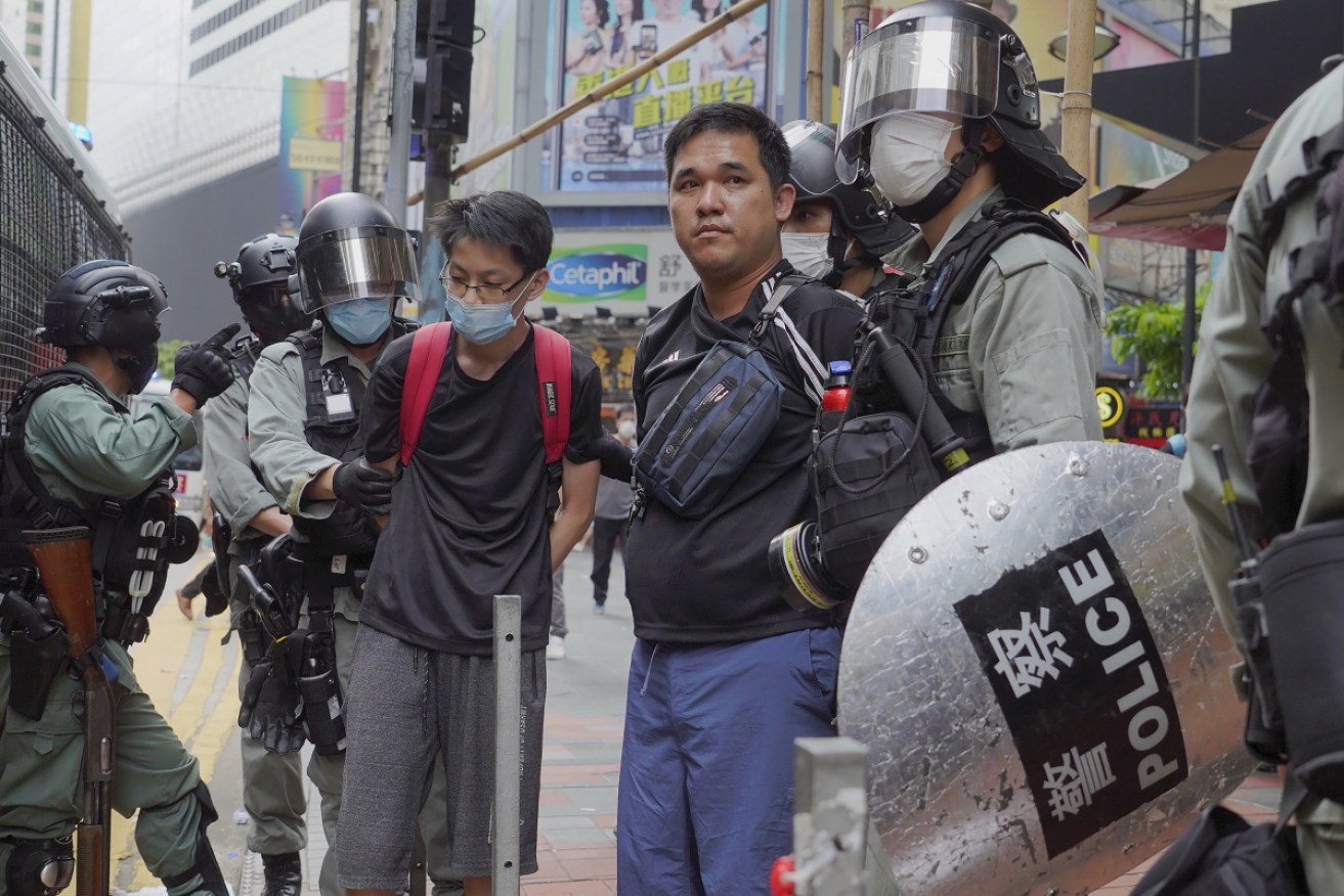 Riot police detain protesters during a demonstration against Beijing's national security legislation at Causeway Bay on Sunday.