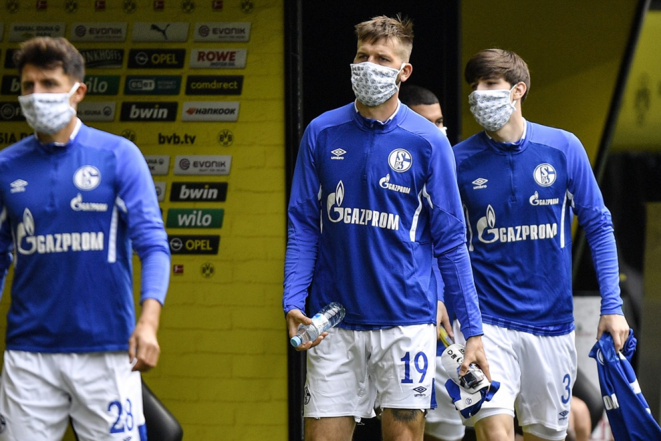 Schalke's Guido Burgstaller arrives with a face mask before the weekend's German Bundesliga match against Borussia Dortmund.