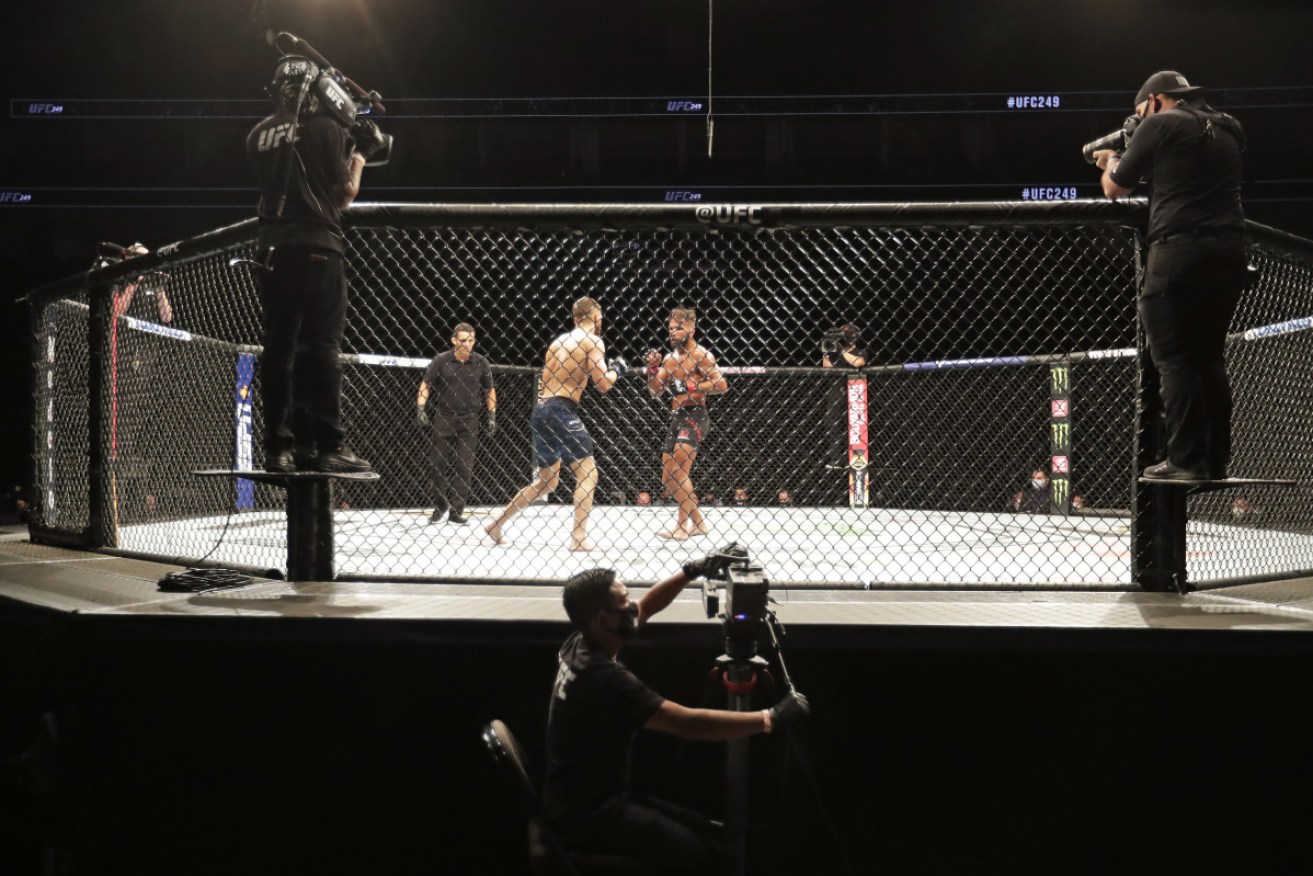 Calvin Kattar and Jeremy Stephens fight during an eerily quiet UFC 249 on Sunday in Jacksonville, Florida.