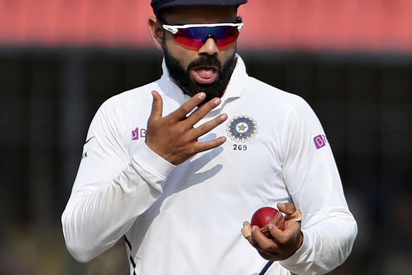 India captain Virat Kohli shines the ball in a Test against Bangladesh in a practice that could soon be banned. 