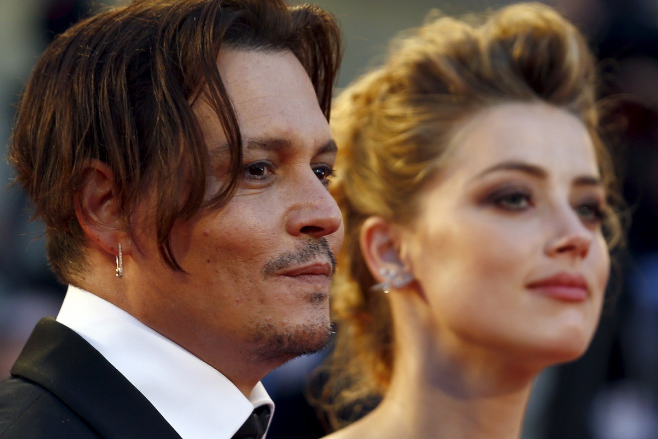Amber Heard with then husband Johnny Depp at <i>The Danish Girl</i> premiere at Venice in September 2015. 