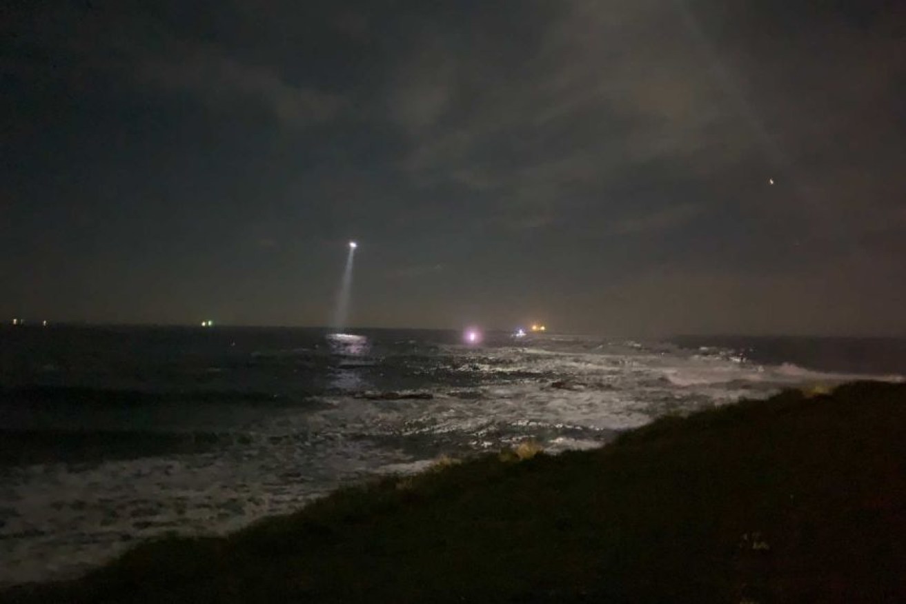 Police searched the ocean off Bulli Beach on Saturday night for a missing man and child.