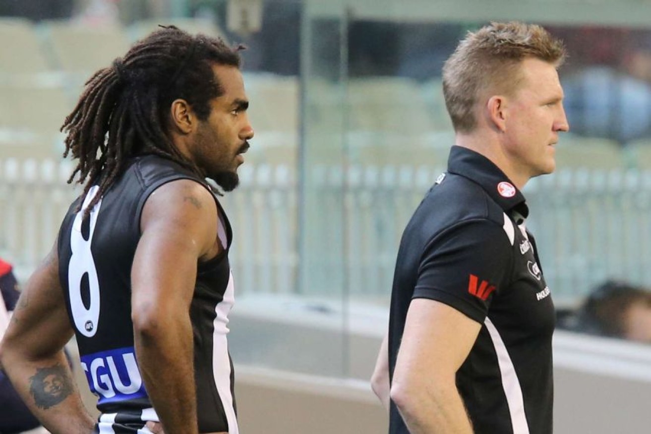 Collingwood coach Nathan Buckley (right) says he never heard former player Heritier Lumumba being called a "chimp" during his time at the club.