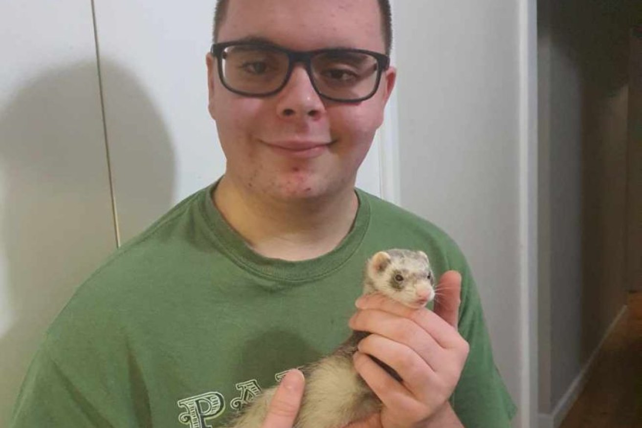 Xavier Hamilton with his rescued ferret Trixie.  