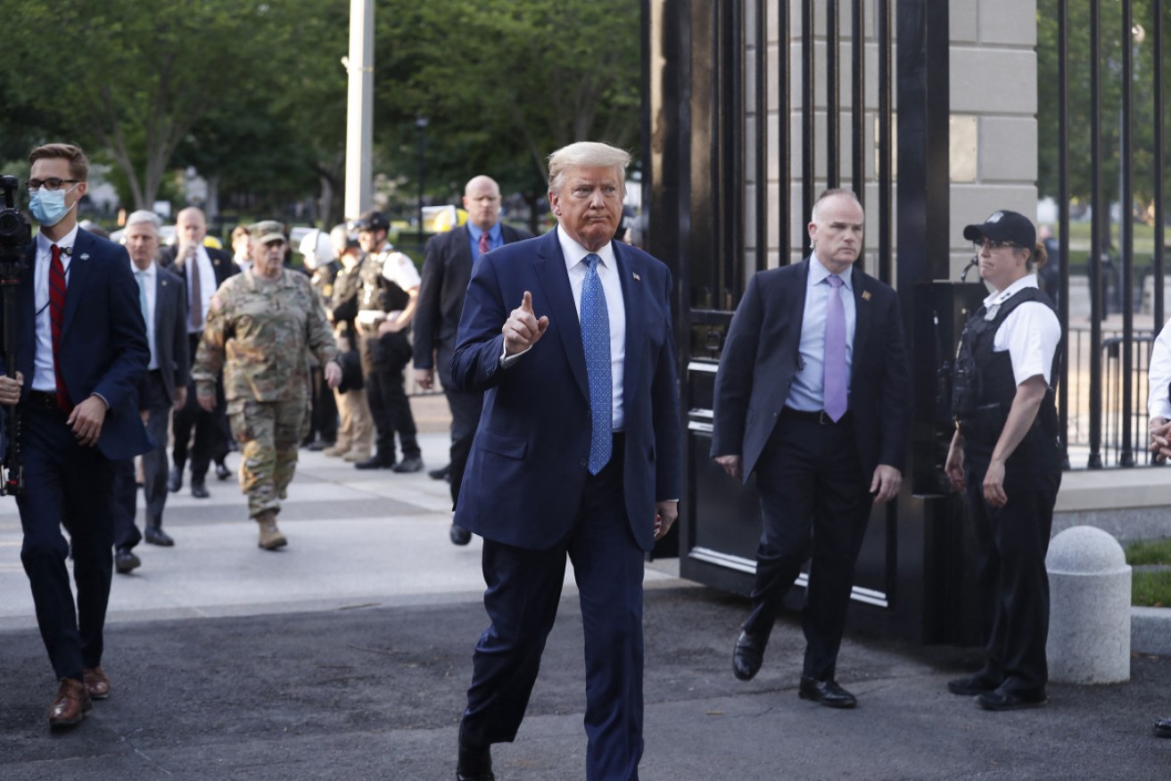 Surrounded by secret service agents, Mr Trump headed out the gates of the White House onto the streets with protesters just hundreds of metres away.