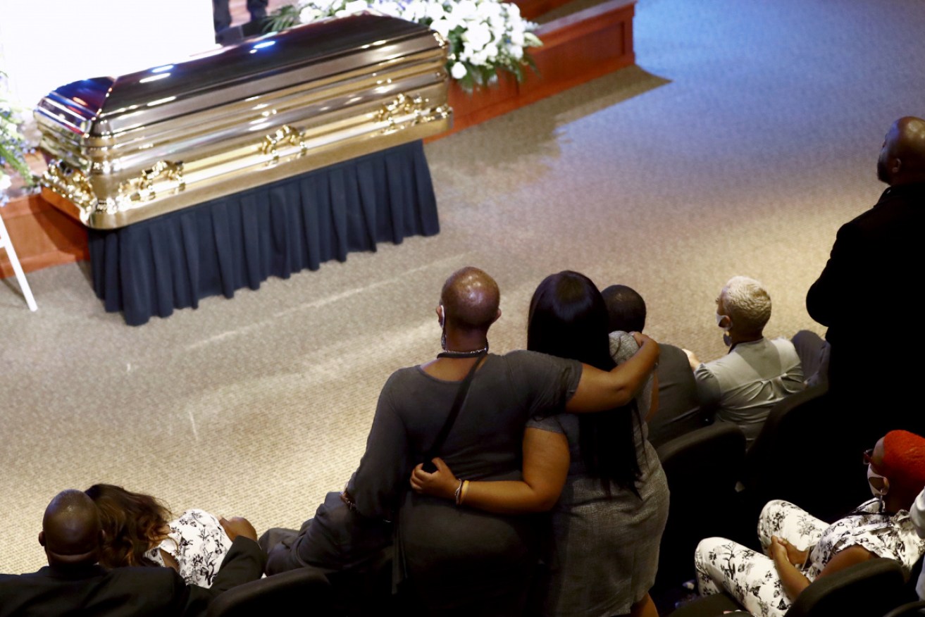 Members of George Floyd's family stand as the Rev. Al Sharpton speaks at a memorial service for Floyd at North Central University.