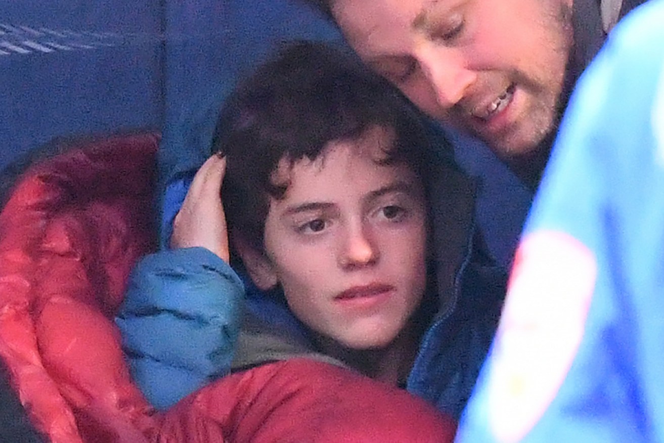 William Callaghan with stepfather Nathan Hazard immediately after his rescue.