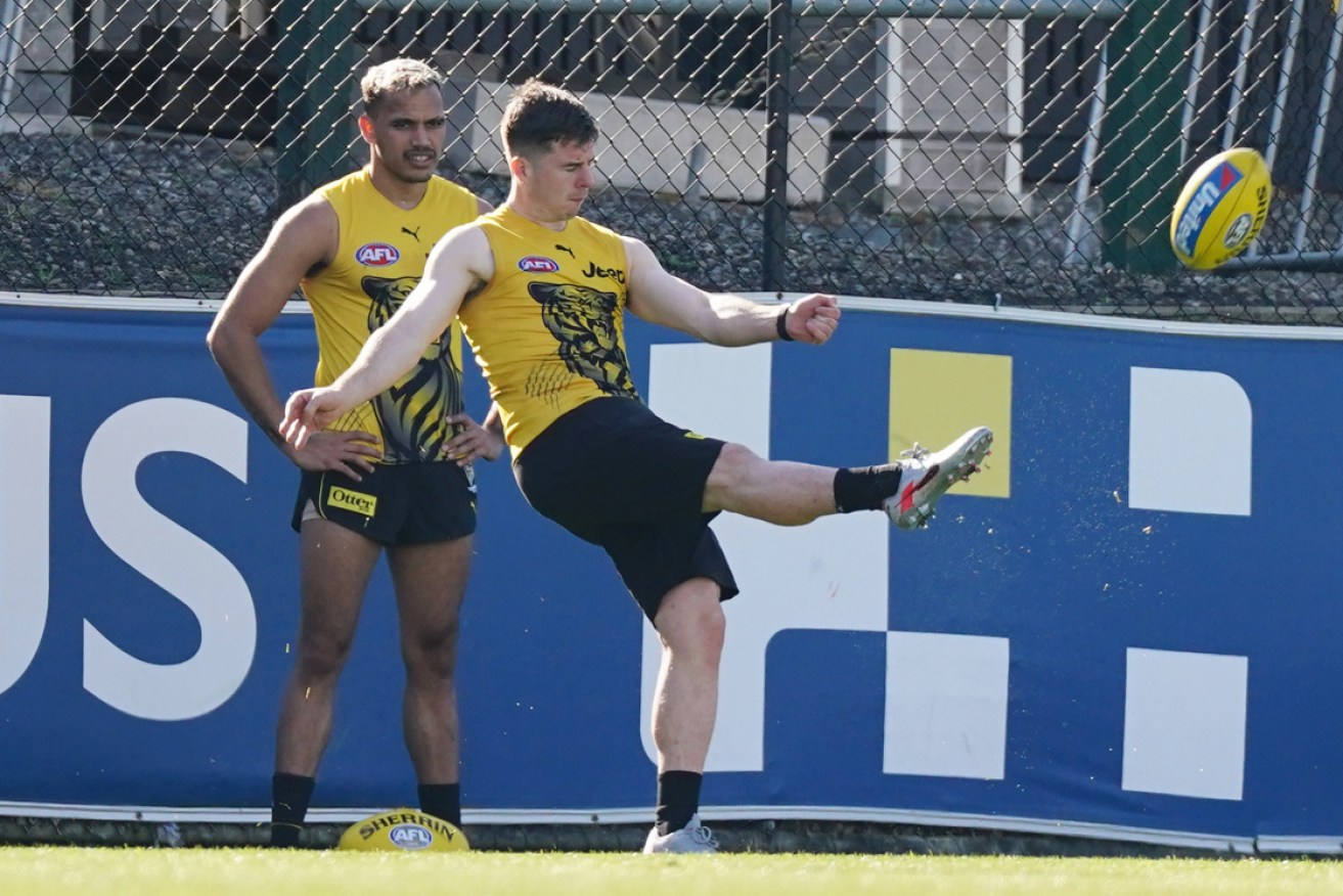 Jack Higgins takes pot shots at Richmond training as teammate Sydney Stack looks on.