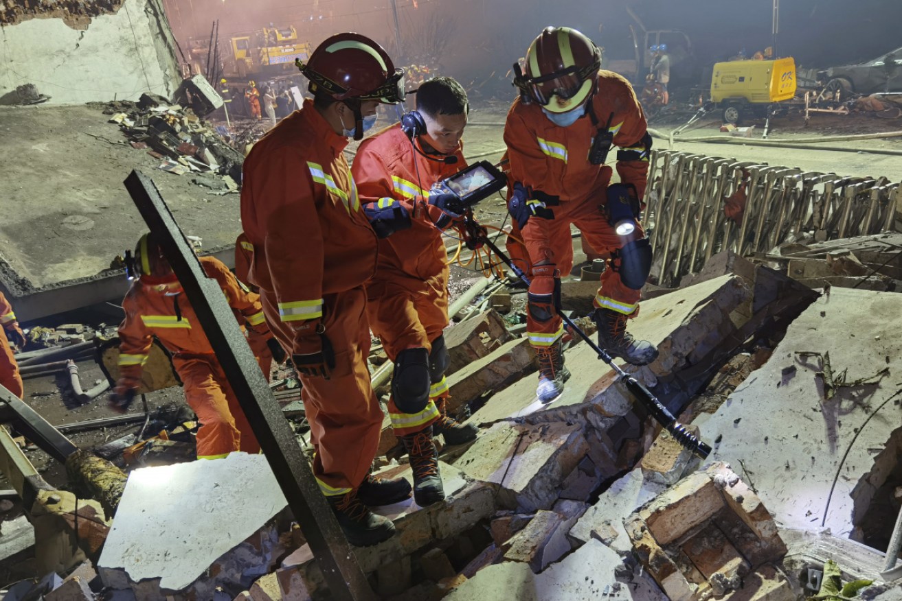 Firefighters look for bodies in the rubble after Saturday's explosion.