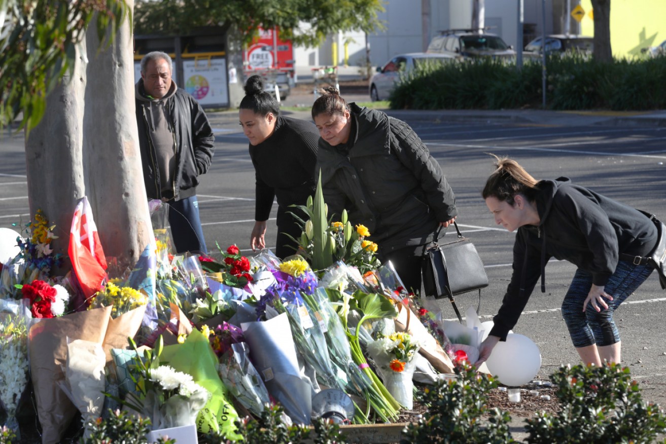 Mourners leave flowers at the scene where Solomone Taufeulungaki was killed.