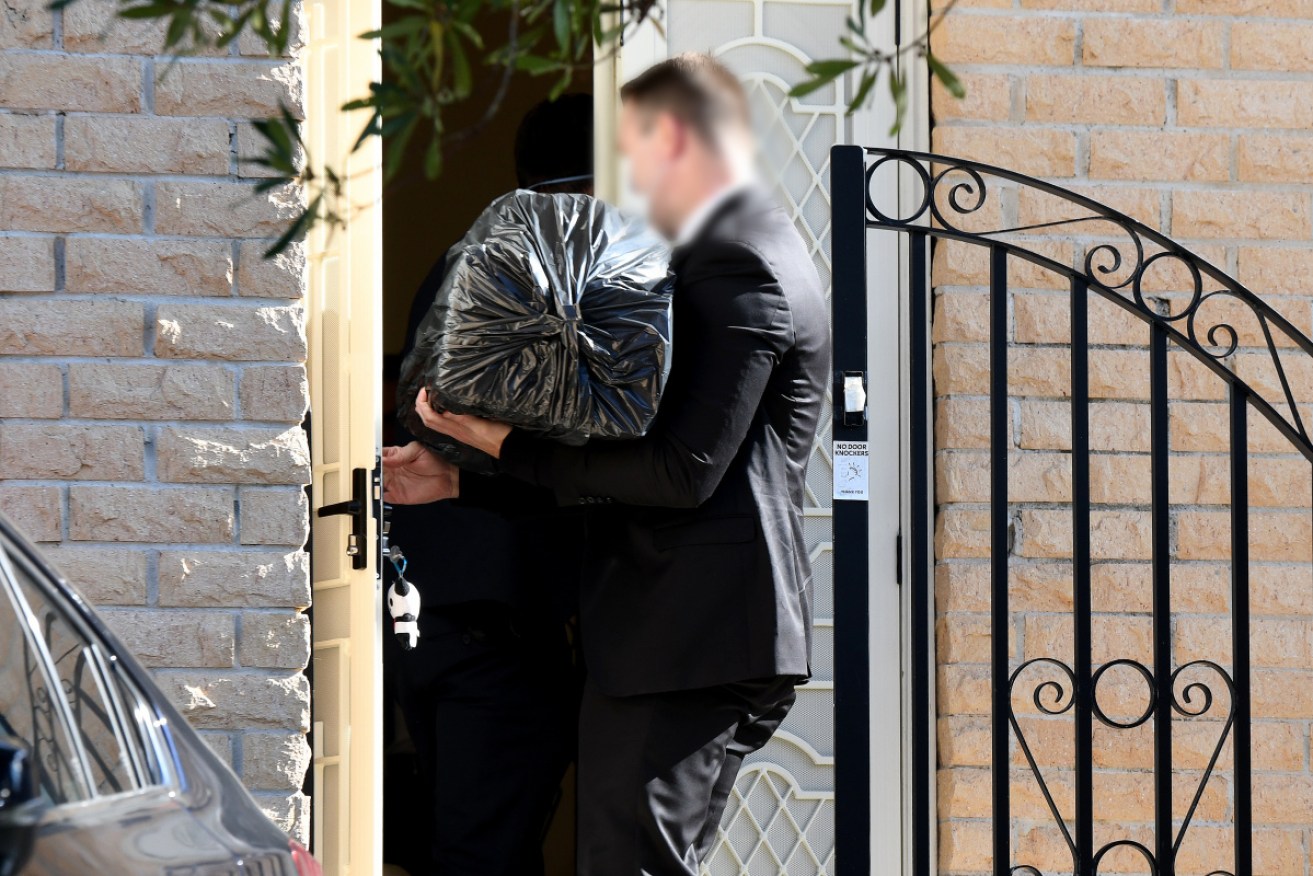 An AFP officer enters the Sydney home of NSW Labor MP Shaoquett Moselmane on Friday.
