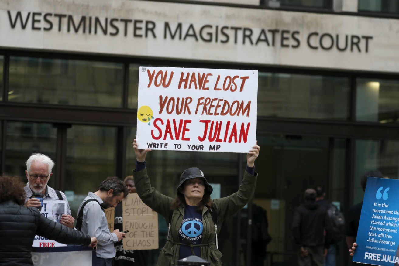 Supporters of WikiLeaks founder Julian Assange protest in front of Westminster Magistrates Court in London on Monday.