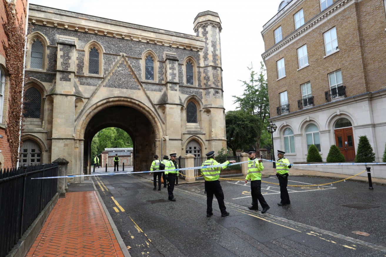 Police stand guard at the Abbey gateway of Forbury Gardens park in Reading on Sunday following Saturday's stabbings. 