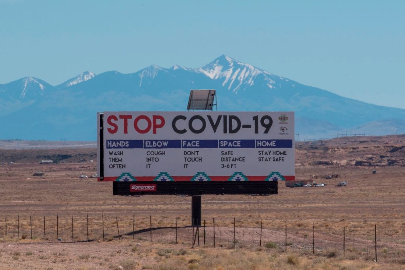 A sign warns against the COVID-19 virus near the Navajo Indian nation town of Tuba City, Arizona.