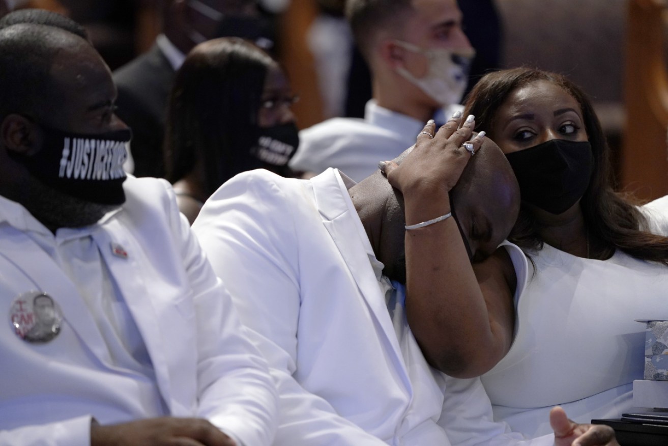 Philonise Floyd (C) is comforted during the funeral service for his brother George Floyd.
