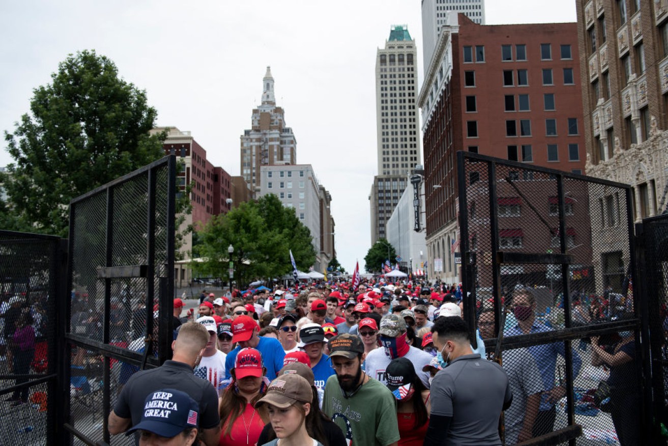 People wait at a security checkpoint to attend the Tulsa rally.
