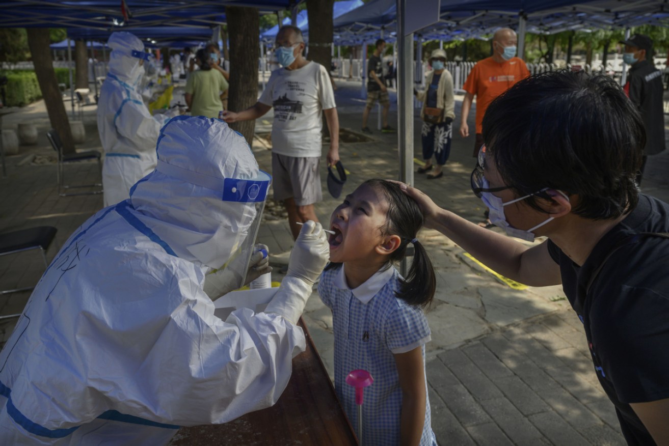 A young girl is given a swab test in Beijing on Monday. 
