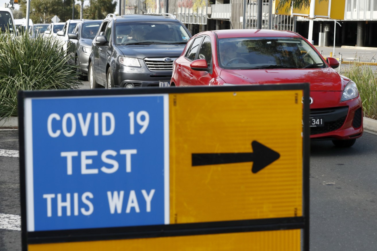Drivers queue at Highpoint Shopping Centre, in Melbourne's west, for virus testing.