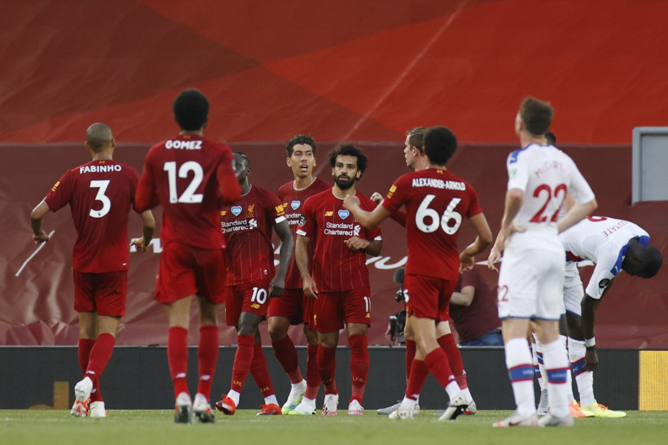 Mohamed Salah of Liverpool celebrates with his team after scoring.