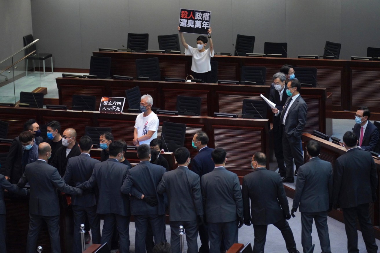 Pro-democracy lawmaker Tanya Chan, protests after Hong Kong’s legislature approved a bill that makes it illegal to insult the Chinese national anthem. 