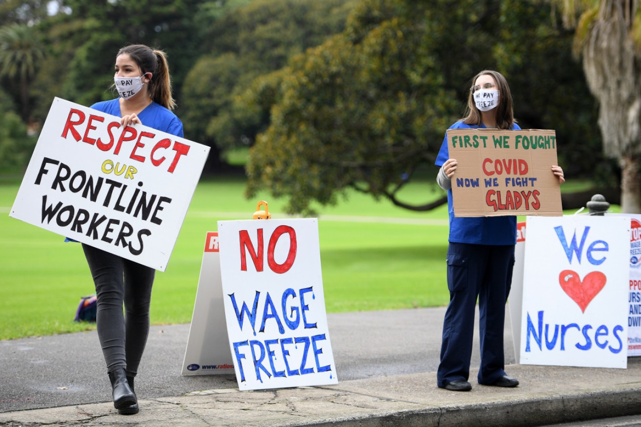 Demonstrators outside NSW State Parliament in Sydney on Tuesday plea for the pay freeze proposal to be beaten.