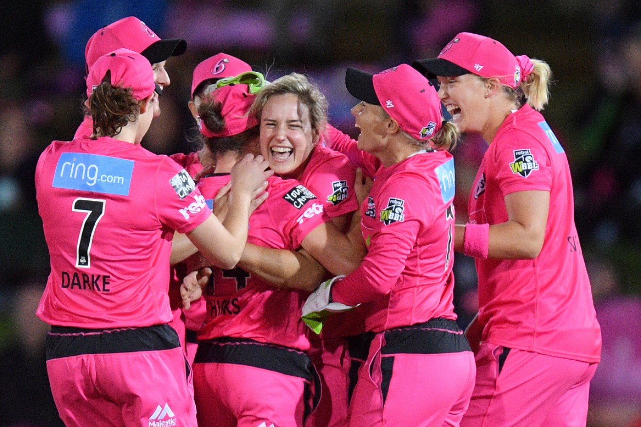 The Women's Big Bash League, in which Ellyse Perry celebrates with Sydney Sixers teammates,  will be unaffected by the changes. 