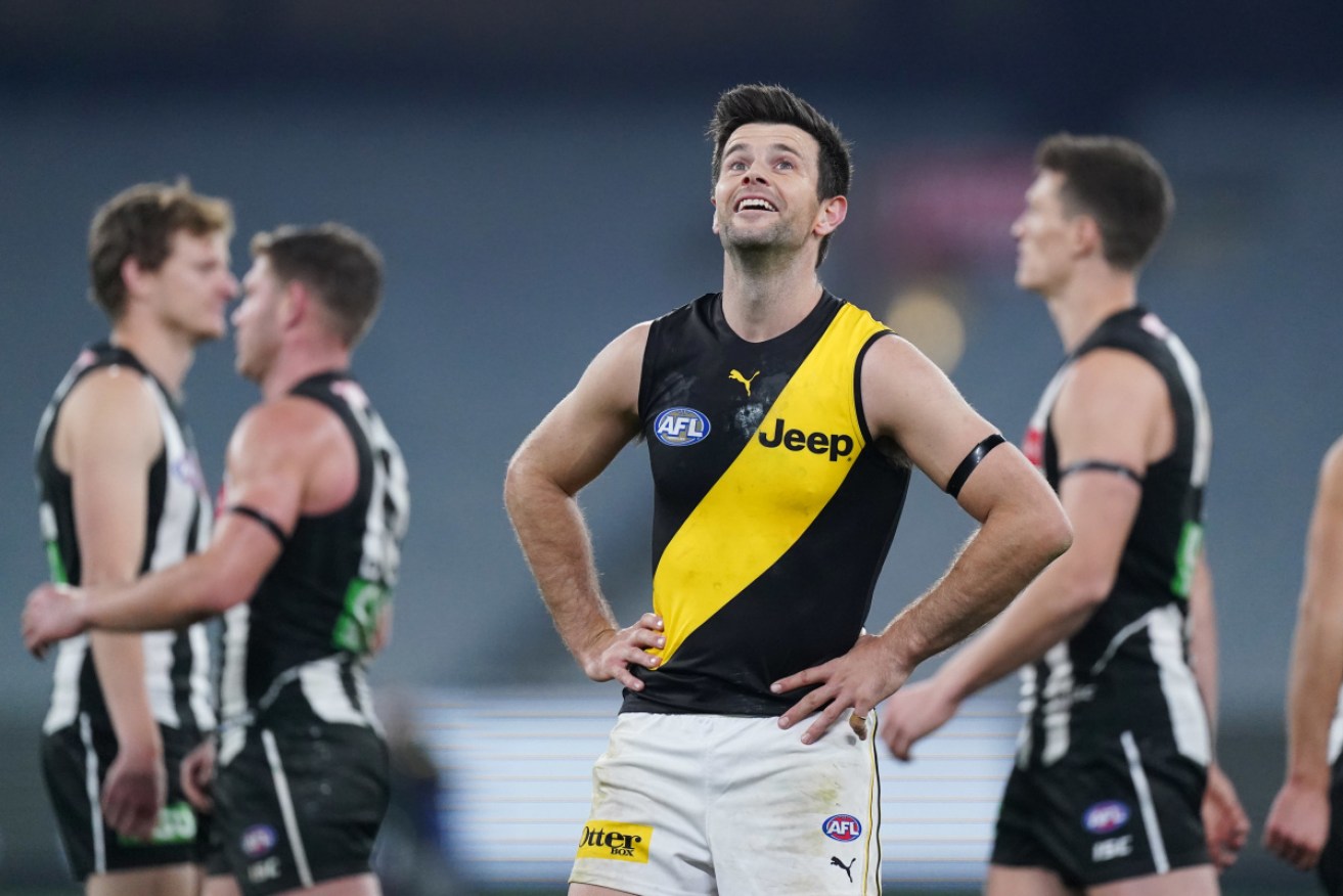 Trent Cotchin can only smile despite the draw against Collingwood that resumed the AFL season on Thursday night. 